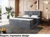 A bedroom scene featuring a large upholstered bed with a mattress and topper, a bedside table, and decorative elements. Produktbild-Vorschau