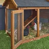 A wooden chicken coop with a wire enclosure, situated on a grassy lawn with three chickens inside. Anteprima dell’immagine prodotto