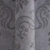 A close-up view of a textured wallpaper with a damask pattern. Produktbild-Vorschau