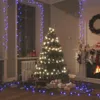 A festive Christmas scene with a decorated tree, fireplace, stockings, and gifts, illuminated by blue LED lights. Produktbild-Vorschau