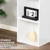 A close-up view of a white shelf unit with decorative items and text overlays. Produktbild-Vorschau