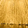A close-up view of a string of warm white LED lights with feather accents, hanging against a sheer white curtain. Produktbild-Vorschau