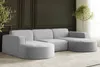 A modern living room with a large, light gray sectional sofa.