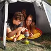 Two people inside a tent, with a portable stove. Podgląd zdjęcia produktu