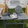A dark gray metal side table with a slatted top, placed outdoors on a lawn next to wicker chairs. A vase with branches and a decorative cup are on the table. Náhled obrázku produktu