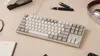 A keyboard and office supplies on a desk. Produktbild-Vorschau