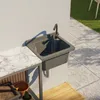 An outdoor sink and countertop setup with gardening supplies. Náhled obrázku produktu