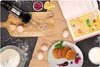 A flat lay scene depicting ingredients and a hand mixer for making pancakes, with a recipe book open. Náhľad obrázku produktu