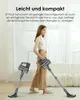 A woman is holding a cordless vacuum cleaner, with another vacuum cleaner standing nearby. Produktbild-Vorschau