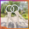 Close-up of two metal rings with beige ropes attached, against a blurred outdoor background. Voir les images du produit