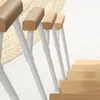 A close-up view of a white metal railing with wooden handrails on a staircase. Produktbild-Vorschau