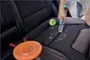 A person is cleaning a car seat with a cleaning device, with a dog toy and a frisbee nearby. Podgląd zdjęcia produktu