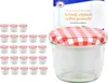 A set of small glass jars with red and white checkered lids, alongside a product box with text. Anteprima dell’immagine prodotto