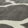 A close-up view of a rug with a gray and white pattern. Produktbild-Vorschau