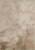 A close-up view of a rug with a distressed, abstract pattern. Produktbild-Vorschau