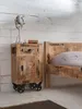 A bedside table and a bed in a bedroom setting. Produktbild-Vorschau