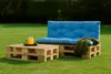 Outdoor furniture set made of wooden pallets with blue cushions on a grassy lawn. Produktbild-Vorschau