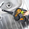 A person is cleaning a multi-compartment frying pan with a sponge in a kitchen sink. Náhľad obrázku produktu