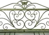 A close-up of the decorative metalwork on the top of a garden bench. Anteprima dell’immagine prodotto
