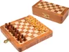 A wooden chess set with pieces arranged on the board, and the closed chess box is in the background. Podgląd zdjęcia produktu