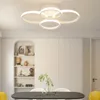 A modern dining room with a sleek ceiling light fixture above a table. Podgląd zdjęcia produktu
