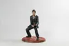 A figurine of Tony Montana from Scarface is displayed on a circular red base against a white background. Podgląd zdjęcia produktu