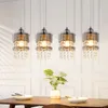 Four pendant lights hanging above a dining table with a plant and place settings. Podgląd zdjęcia produktu