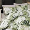 A close-up view of bedding with a tropical leaf pattern. Produktbild-Vorschau