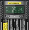 A close-up view of a Nitecore UM4 battery charger with batteries inserted and the display screen showing charging status. Náhled obrázku produktu