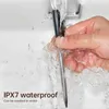 A hand washing a black and silver digital thermometer under running water. Podgląd zdjęcia produktu