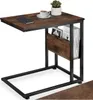 A side view of a C-shaped side table with a wooden top and shelves, black metal frame, and a small potted plant and coffee cup on top. Náhled obrázku produktu