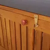 A close-up view of a wooden storage bench with a red knob and a gold latch. Anteprima dell’immagine prodotto