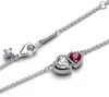A close-up shot of a silver Pandora necklace with two heart-shaped pendants, one clear and one red, set against a white background. Produktbild-Vorschau