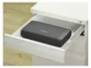 A black Canon printer is placed inside an open white drawer of a filing cabinet. Podgląd zdjęcia produktu