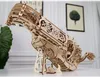 A wooden 3D puzzle of a musical instrument on a white surface, with two framed pictures on the wall behind it. Produktbild-Vorschau
