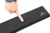 A hand is pressing down on a black wrist rest. Podgląd zdjęcia produktu