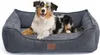 A dog is lying on a dog bed.