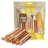 A bag of dog treats with some treats spilled in front. Produktbild-Vorschau