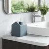 A bathroom vanity with a tissue box, sink, and faucet. Anteprima dell’immagine prodotto