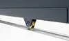A close-up view of a gray sliding gate wheel on a metal track. Produktbild-Vorschau