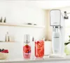 A SodaStream sparkling water maker with a bottle of red berry syrup and a glass of red berry flavored sparkling water on a kitchen counter. Anteprima dell’immagine prodotto