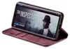 A smartphone in a burgundy flip case is displayed at an angle, showing the phone's screen which displays a movie poster for 'The Inspector'. Produktbild-Vorschau