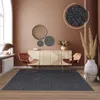 A modern living room with a rug, chairs, and a sideboard. Produktbild-Vorschau