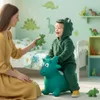 A mother and child playing with a dinosaur toy in a child's room. Podgląd zdjęcia produktu