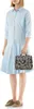 A person is holding a handbag while wearing a dress and shoes. Produktbild-Vorschau