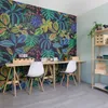 A home office setup with a tropical-themed wallpaper, two desks, and chairs. Anteprima dell’immagine prodotto