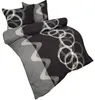 A bedding set with a black and gray abstract pattern, including circles and wavy lines, is displayed on a white background. Produktbild-Vorschau