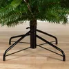 Close-up of the base of an artificial Christmas tree, showing the stand and lower branches. Podgląd zdjęcia produktu