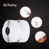 A product image featuring two rolls of white hook and loop tape, with three circular close-up insets showing details of the product and its application. Náhled obrázku produktu
