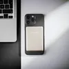 A laptop and a phone with a power bank attached are placed on a surface with contrasting black and white sections. Voir les images du produit